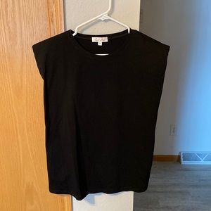 Sleeveless black top with shoulder pads